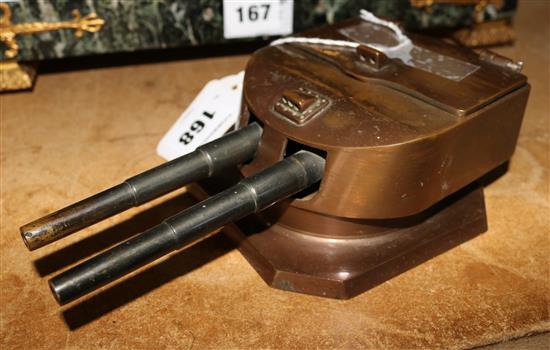 A 1920s brass inkwell modelled as a battleship gun turret cast from the scrapped German battleship Helgoland(-)